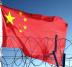 Chinese flag behind barbed wire